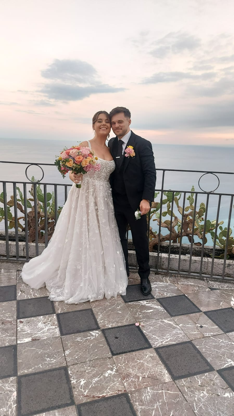 Elegant Sicilian terrace overlooking Taormina, set for a wedding celebration at golden hour